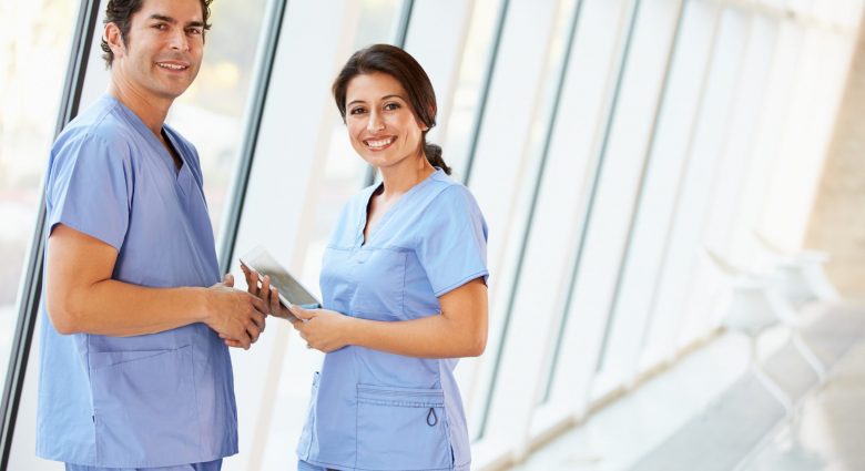 Medical staff talking in hospital corridor.